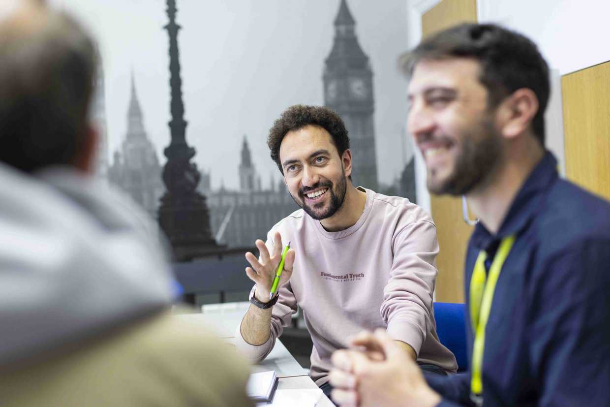 Students at school having a relaxing discussion in front a panel showing london